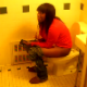 A black girl is video recorded as she takes a shit in a public restroom. Clip is very brief, and no audible pooping sounds can be heard.